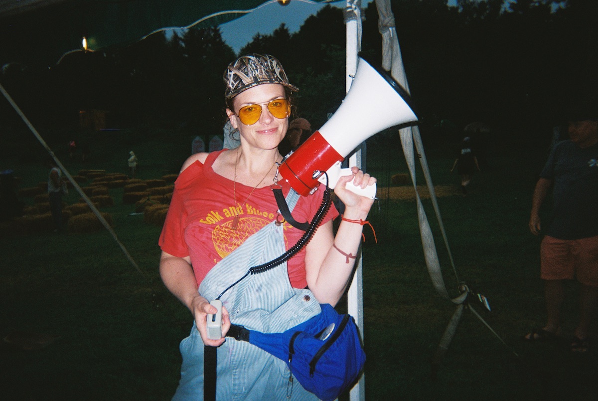 Emcee Mary Williamson holds a megaphone.